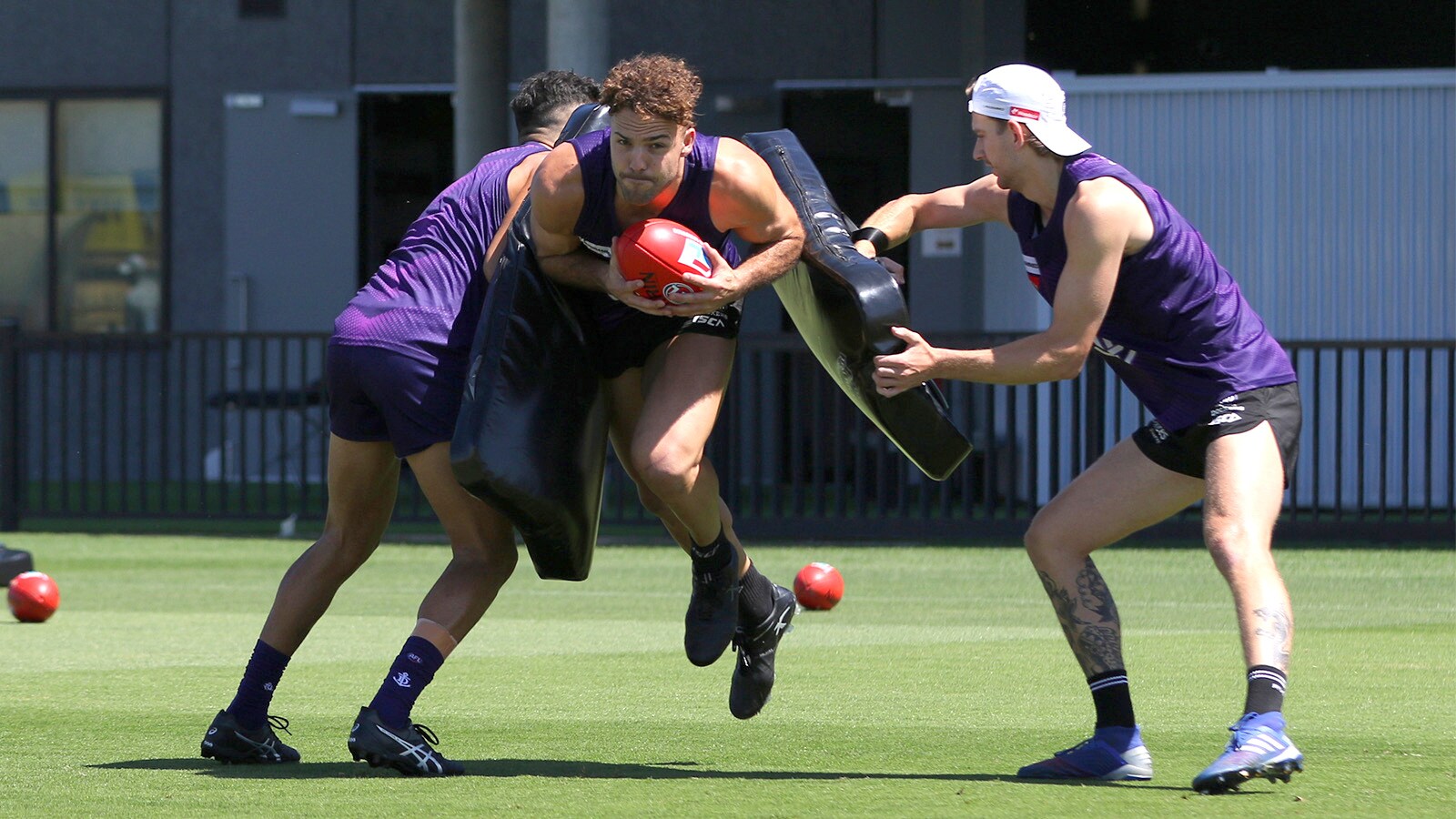 report web 611.jpg Griffin Logue, Jason Carter and Taylin Duman in action at training on Wednesday. - Fremantle,Fremantle Dockers